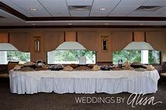 a banquet table set up in front of large windows