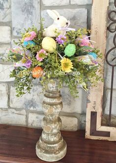 a vase filled with flowers on top of a wooden table