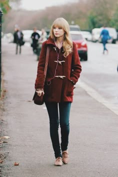 four different pictures of women in coats and jeans, one is wearing a beanie