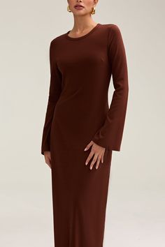 Introducing the Ella Ribbed Split Cuff Maxi Dress, a luxurious and versatile addition to your wardrobe. Made with ribbed fabric for a comfortable and stretchy fit, this dress features a split cuff detail and pairs perfectly with an abaya. Elevate your style and make a statement with this elegant and exclusive piece. Model is 5'7 wearing size S/58"