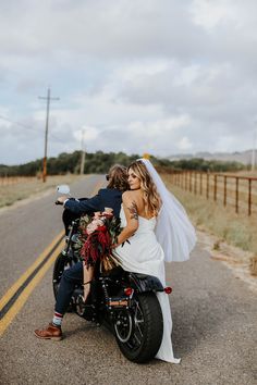 a bride and groom riding on the back of a motorcycle