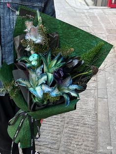 a person holding a bouquet of flowers on the street