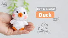 a small crocheted duck sitting in someone's hand with the words how to crochet on it