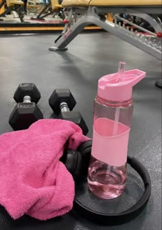 a pink towel and some dumbs on a table