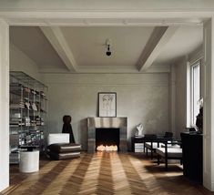 a living room filled with furniture and a fire place in the middle of the room