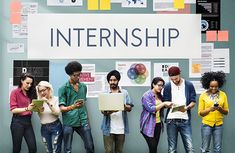 group of people standing in front of a sign with the words internship on it