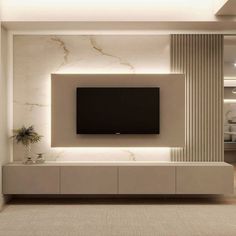 a tv mounted on the wall in a living room with white walls and flooring