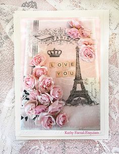 a card with pink roses and the eiffel tower