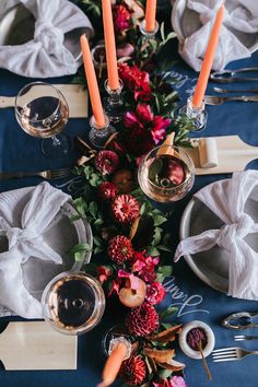 the table is set with flowers and candles