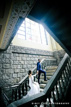 the bride and groom are walking down the stairs