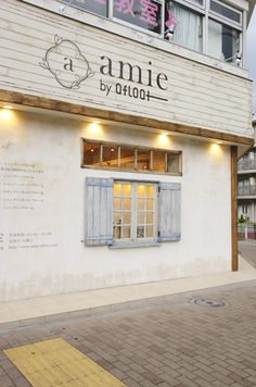 an old building with blue shutters on the front and windows that read annie by 8000