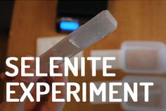 a person holding a plastic object with the words selenite experiment in front of them