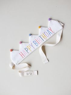 a happy birthday banner is laying on the floor