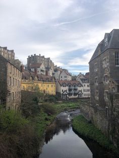 a river running through a city next to tall buildings