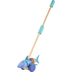 a wooden toy with a shark on it's side and a long stick attached to the handle