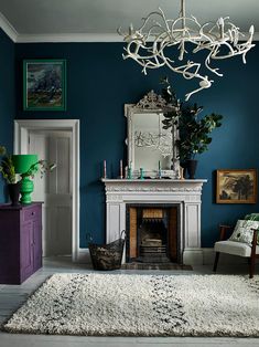 a living room filled with furniture and a fire place covered in antelope branches