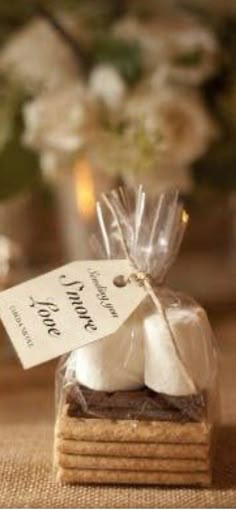 a stack of cookies wrapped in cellophane and tied with a ribbon, sitting on a table