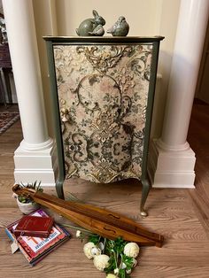 an ornate cabinet next to some flowers on the floor