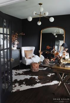 a living room filled with furniture and a large mirror on top of a wooden table