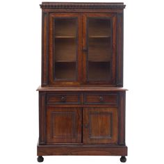 an old wooden cabinet with glass doors on the top and bottom shelf, against a white background