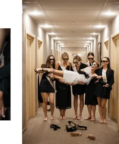 a group of women standing around each other in a hallway with shoes on the floor