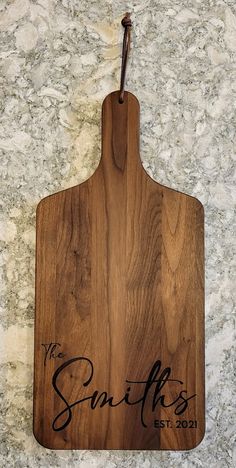 a wooden cutting board with the words, the smiths on it