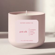 a pink candle sitting on top of a table