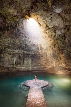 a person standing in the middle of a cave