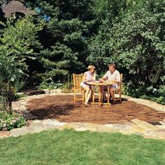 two people sitting at a table in the middle of a garden