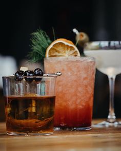 two cocktails sitting next to each other on a table