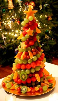 a christmas tree made out of fruit on a plate