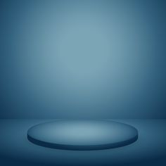 an image of a blue background with a round object on the floor in the foreground