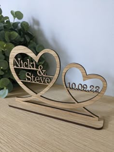 two wooden hearts with the names nick and steve on them