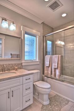 a bathroom with a sink, toilet and shower