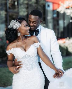 a bride and groom holding each other close together