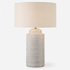 a white table lamp with a beige shade