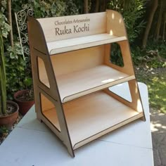 a wooden shelf sitting on top of a white table