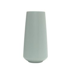 a white vase sitting on top of a table