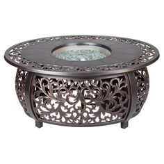 an ornate metal table with glass top