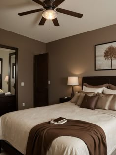 a bedroom with a bed, mirror and ceiling fan