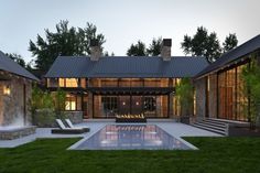 a house with a pool in the middle of it and lots of windows on each side