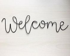 the word welcome written in black wire on a white background