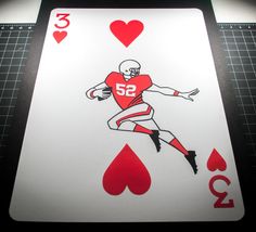 a playing card with an image of a football player in red and white on it