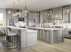 a large kitchen with gray cabinets and an island in the middle is shown, along with two bar stools