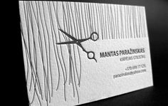 a business card with scissors on it and the words mantas - paradisks