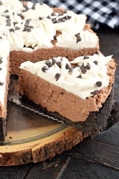 a chocolate pie with white frosting and chocolate chips on top is cut into slices