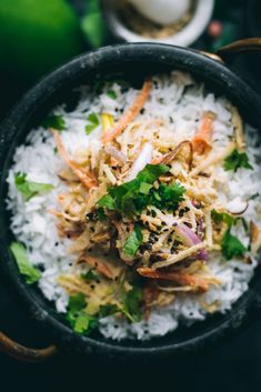 a bowl filled with rice and vegetables on top of a table