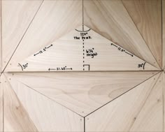 a wooden panel with measurements for the top and bottom pieces on it, as well as an arrow