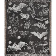 a black and white photo of bats on a blanket with flowers, plants and mushrooms