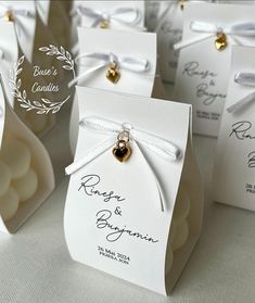 small wedding favors with gold bells and ribbons